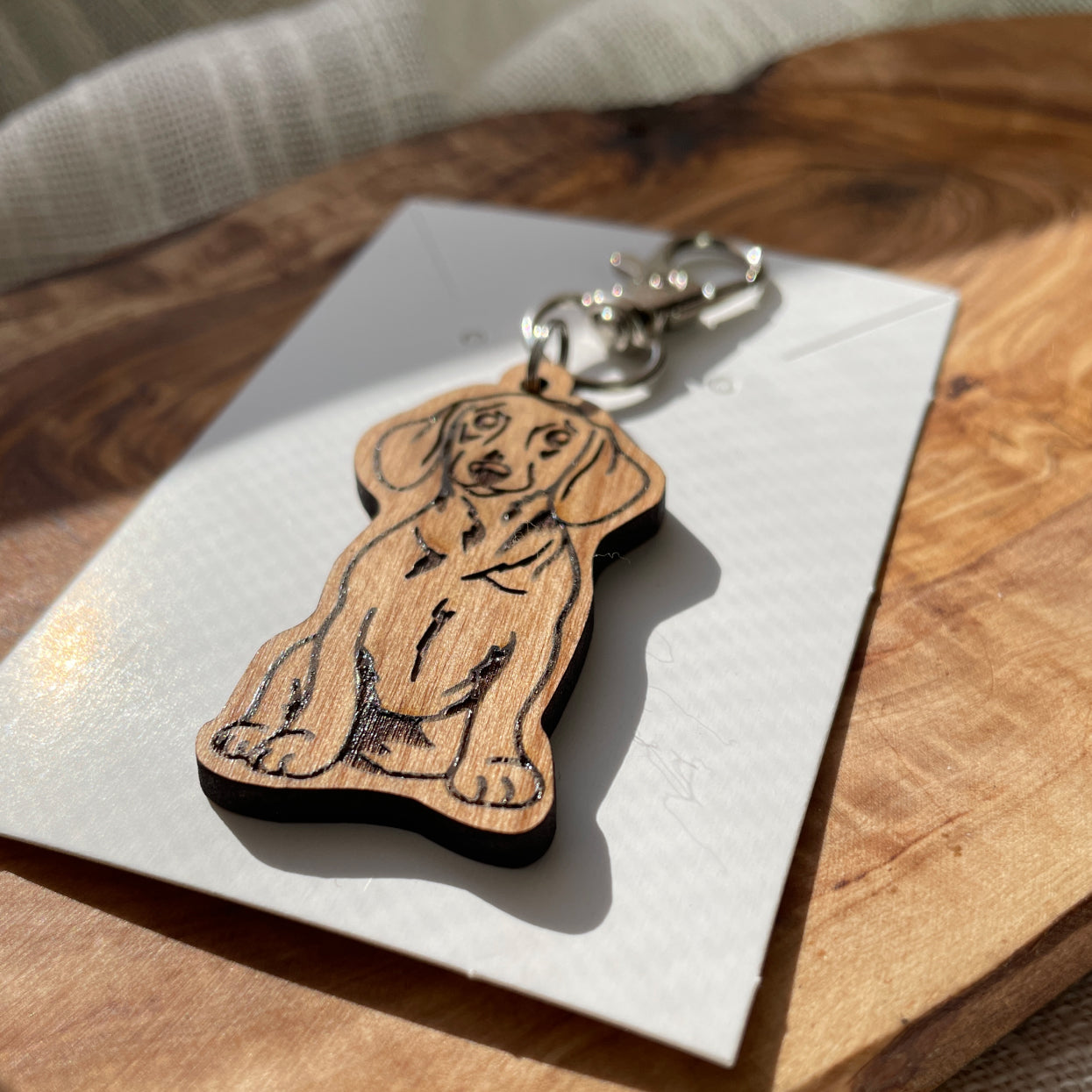 dog wooden keychain laying flat