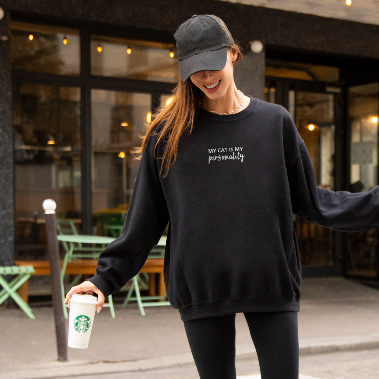 "My cat is my personality" black crewneck on a girl with starbucks coffee